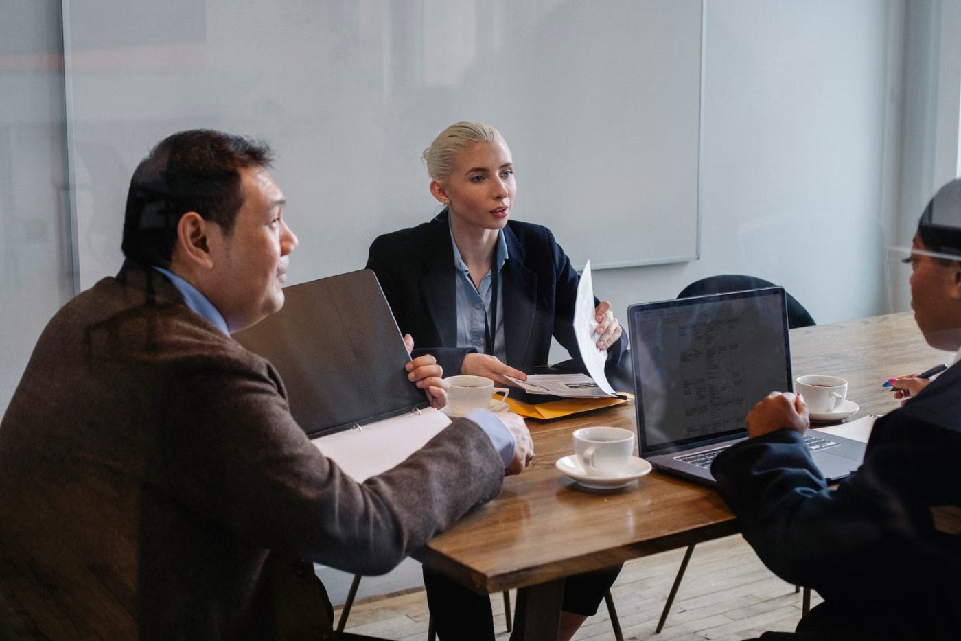 Advisers reviewing restructuring documents around a table